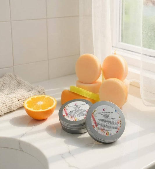 orange shampoo bar with labels on a bathroom counter with oranges and a towel.